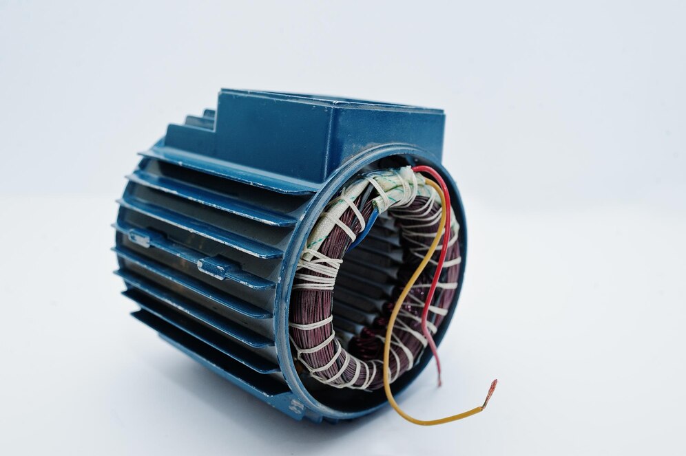 Close-up of an electric motor stator with exposed copper windings and wiring.